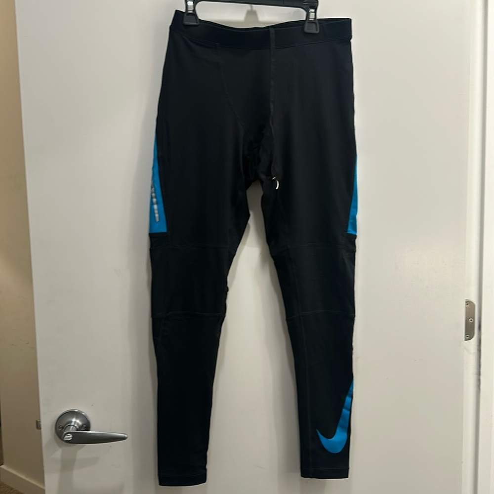 Nike running leggings with reflective  sides. Small pocket for keys on back.